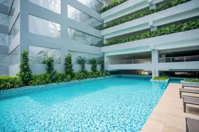 an image of a building with a swimming pool at Neu Suites by COBNB in Kuala Lumpur