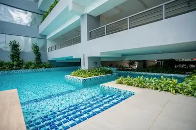 a swimming pool in the middle of a building at Neu Suites by COBNB in Kuala Lumpur