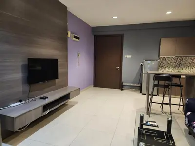 a large living room with a flat screen tv at Regalia Suites KL Infinity Pool _ by MygeHomes in Kuala Lumpur