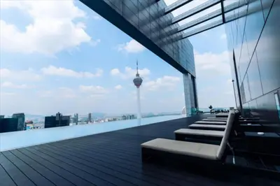 a balcony with benches and a view of a city at Maxhome Plus @ The Platinum KLCC in Kuala Lumpur