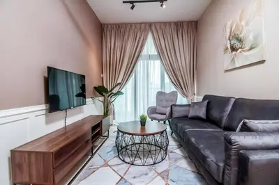 a living room with a couch and a tv at Legasi Kampung Baru - Idealhub in Kuala Lumpur