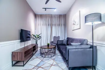 a living room with a couch and a tv at Legasi Kampung Baru - Idealhub in Kuala Lumpur