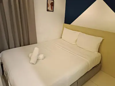 a bed with a white towel sitting on it at S20- Bedroom Bukit Bintang Robertson with Netflix in Kuala Lumpur