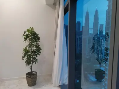 a plant sitting in a room next to a window at EATON RESIDENCE AT KLCC in Kuala Lumpur