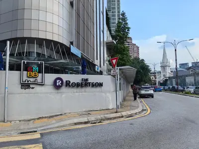 a building with a sign on the side of a street at The Robertson S22 Jalan Alor Petaling Street Bukit Bintang KL 3R2B 8Pax in Kuala Lumpur