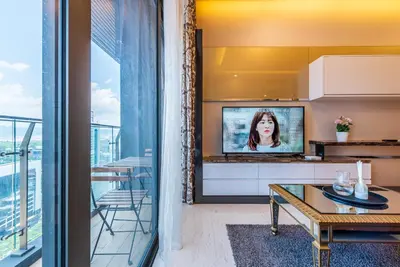 a living room with a tv and a table at Dorsett Residence Kuala Lumpur 17 in Kuala Lumpur