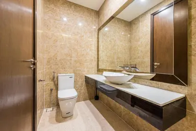 a bathroom with a toilet and a sink and a mirror at Dorsett Residence Kuala Lumpur 17 in Kuala Lumpur
