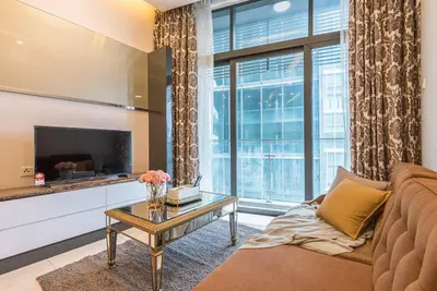 a living room with a couch and a table at Dorsett Residence Kuala Lumpur 14 in Kuala Lumpur