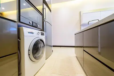 a laundry room with a washing machine in a kitchen at Dorsett Residence Kuala Lumpur 14 in Kuala Lumpur