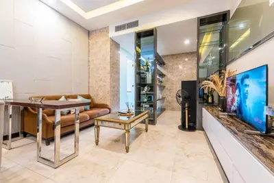 a living room with a couch and a table at Dorsett Residence Kuala Lumpur 12 in Kuala Lumpur