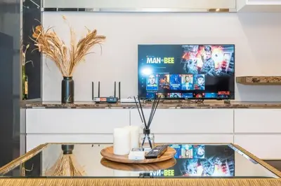 a counter with a tv and a table with candles at Dorsett residence Kuala Lumpur 19 in Kuala Lumpur
