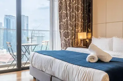 a hotel room with a bed and a large window at Dorsett residence Kuala Lumpur 19 in Kuala Lumpur