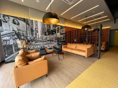 a living room with two couches and a wall mural at The Nova by The City Collection in Kuala Lumpur