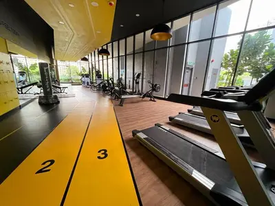 a gym with rows of treadmills in a building at The Nova by The City Collection in Kuala Lumpur