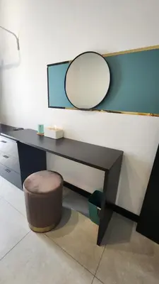 a desk with a mirror and a stool at The Nova by The City Collection in Kuala Lumpur