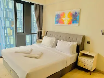 a bedroom with a large bed with white sheets and pillows at Star KLCC by Arman in Kuala Lumpur