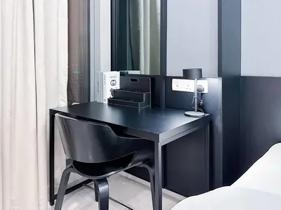 a black desk with a chair in a bedroom at Tropicana The Residence Onebedroom suite by VVHOMESTAY in Kuala Lumpur
