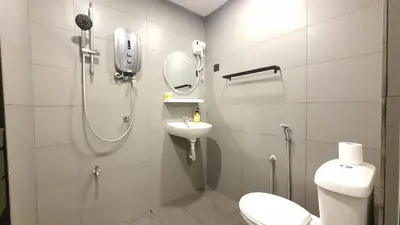 a bathroom with a shower and a toilet and a sink at A Place Like Home Landed House Kuala Lumpur in Kuala Lumpur