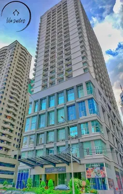 a tall white building with windows on the side of it at Lila Suites Seri Bukit Ceylon in Kuala Lumpur
