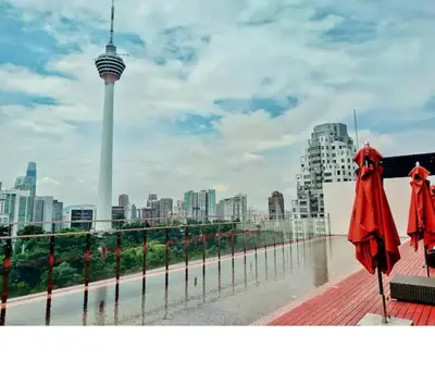 two red umbrellas sitting on a pier with a view of a city at M101 Dang Wangi remote work-friendly suite in Kuala Lumpur