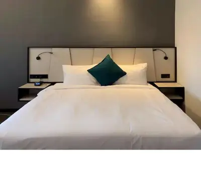 a large white bed with two lamps on top of it at M101 Dang Wangi remote work-friendly suite in Kuala Lumpur