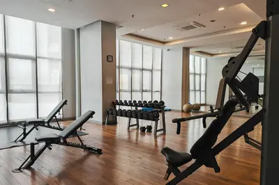 a gym with treadmills and exercise equipment in a room at MyRehat Regalia Residences in Kuala Lumpur
