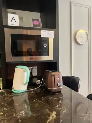 a toaster sitting on a counter next to a microwave at Anggun KL Malaysia in Kuala Lumpur