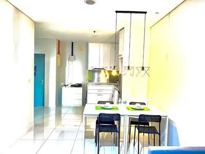 a kitchen with a table and four chairs in it at Summer Suites KLCC By Whollmark in Kuala Lumpur