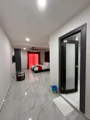 a room with a mirror and a bed in the background at Prime Suite at Ampang - Individual Private Rooms in Kuala Lumpur