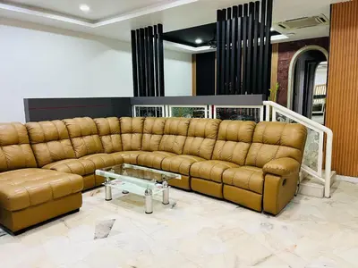 a living room with a brown couch and a table at Prime Suite at Ampang - Individual Private Rooms in Kuala Lumpur
