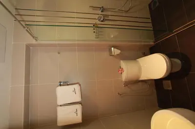 a bathroom with a toilet and two rolls of toilet paper at Tai Ichi Hotel Kuala Lumpur in Kuala Lumpur
