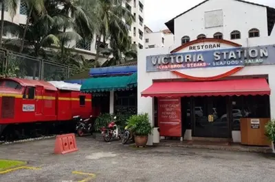a train is parked in front of a building at The Nova by The City Collection in Kuala Lumpur