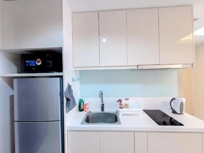 a kitchen with a sink and a refrigerator at Damas Residence Kuala Lumpur in Kuala Lumpur