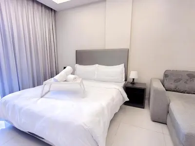 a hotel room with a bed and a couch at Damas Residence Kuala Lumpur in Kuala Lumpur