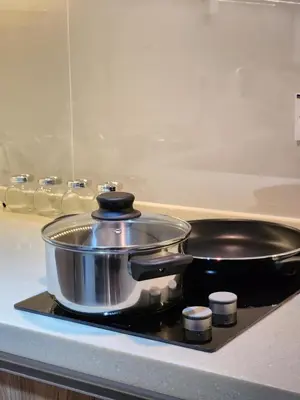 a pot and pan sitting on top of a stove at Mont Kiara The Ooak Suites & Residences l 1BR in Kuala Lumpur