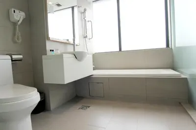 a bathroom with a tub and a toilet and a sink at Pacific Express Hotel Central Market Kuala Lumpur in Kuala Lumpur