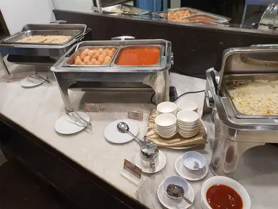 a buffet line with eggs and other food on plates at Pacific Express Hotel Central Market Kuala Lumpur in Kuala Lumpur
