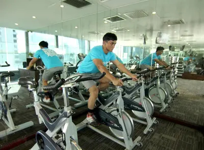 a group of men riding on bikes in a gym at Pacific Express Hotel Central Market Kuala Lumpur in Kuala Lumpur