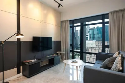 a living room with a couch and a tv at MyRehat Anggun Residences in Kuala Lumpur