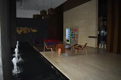 a lobby with chairs and a water fountain in a room at MyRehat Anggun Residences in Kuala Lumpur
