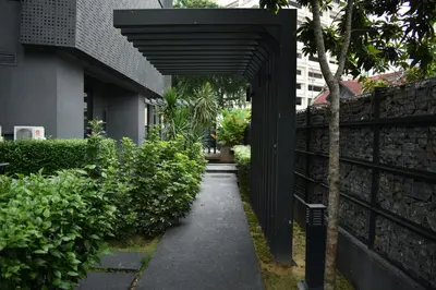 a walkway leading to a building with a black structure at MyRehat Anggun Residences in Kuala Lumpur