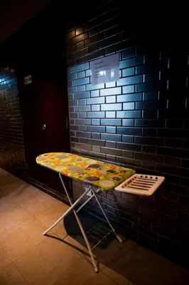 a table in front of a brick wall at Hotel Ambassador @ Bukit Bintang in Kuala Lumpur