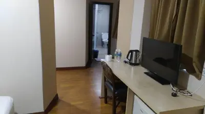 a room with a desk with a flat screen tv at Hotel Ambassador @ Bukit Bintang in Kuala Lumpur