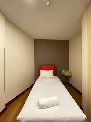 a bed with a red headboard in a room at Hotel Ambassador @ Bukit Bintang in Kuala Lumpur