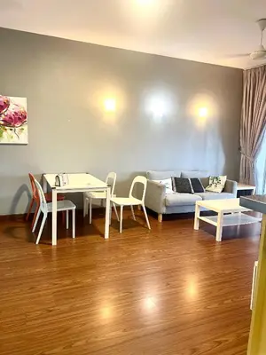 a living room with a couch and a table and chairs at Superb Maya Twin Tower View in Kuala Lumpur