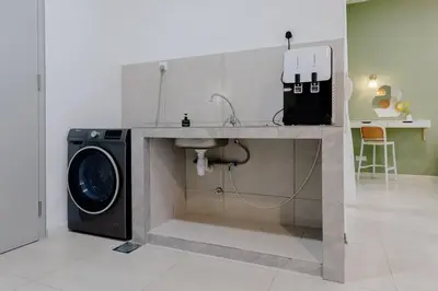 a kitchen with a washing machine and a sink at The Pano Residence Jalan Ipoh Insta-worthy Bath Tub Studio \u6d74\u7f38MRT in Kuala Lumpur