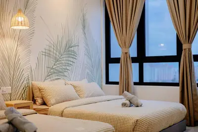 two beds in a bedroom with a teddy bear on the bed at The Pano Residence Jalan Ipoh Insta-worthy Bath Tub Studio \u6d74\u7f38MRT in Kuala Lumpur
