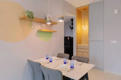 a dining room with a table with blue glasses on it at Datum Jelatek Balcony w Infinity Pool Linked LRT KLCCView Mall in Kuala Lumpur