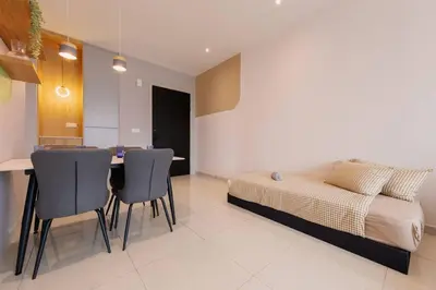 a bedroom with a bed and a table and chairs at Datum Jelatek Balcony w Infinity Pool Linked LRT KLCCView Mall in Kuala Lumpur