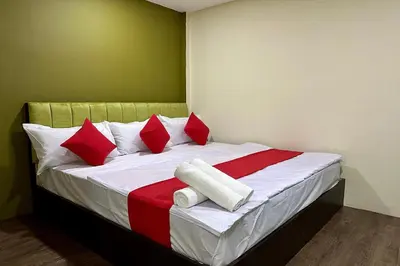 a bedroom with a bed with red and white pillows at Hotel MSP Bukit Bintang in Kuala Lumpur